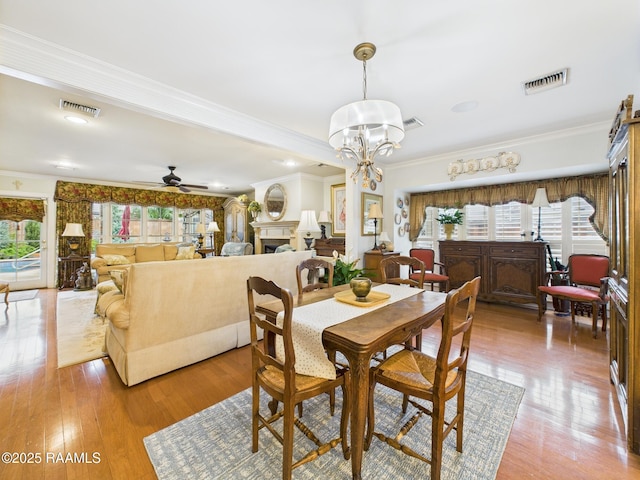 109 Canterbury Rd, Lafayette, LA 70503 - dining room with crown molding, ceiling fan, light wood finished floors, and a chandelier
