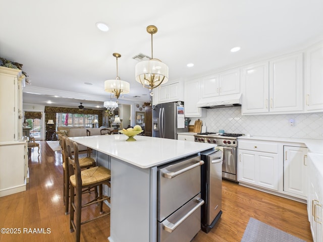 109 Canterbury Rd, Lafayette, LA 70503 - kitchen with light countertops, a chandelier, backsplash, a center island, and white cabinetry