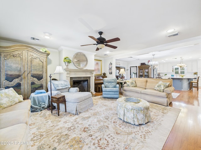 109 Canterbury Rd, Lafayette, LA 70503 - living area featuring ornamental molding, a ceiling fan, light wood-style flooring, recessed lighting, and a premium fireplace
