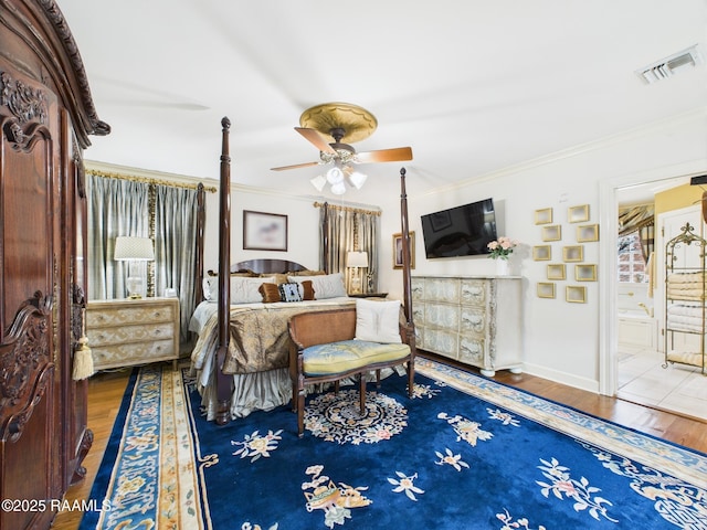 109 Canterbury Rd, Lafayette, LA 70503 - bedroom featuring wood finished floors, ornamental molding, and ensuite bath
