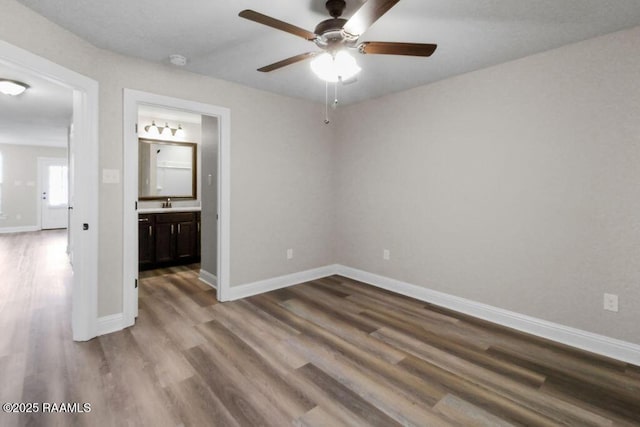 115 Sandstone Ave, Scott, LA 70583 - unfurnished bedroom with wood finished floors, connected bathroom, and ceiling fan