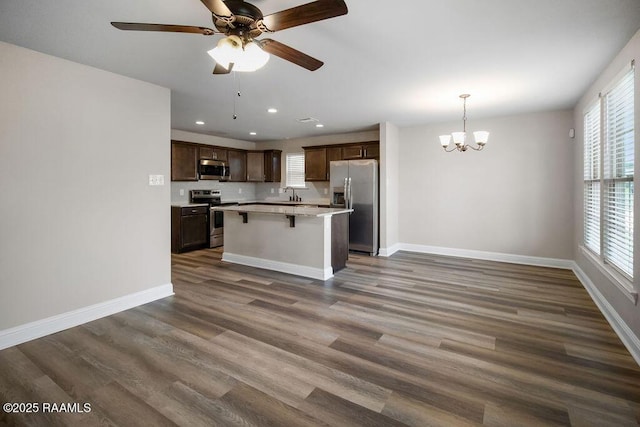 115 Sandstone Ave, Scott, LA 70583 - kitchen featuring appliances with stainless steel finishes, recessed lighting, dark brown cabinets, a chandelier, and healthy amount of natural light