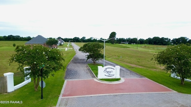 11512 Baker Senior Dr, Abbeville, LA 70510 - surrounding community with curved driveway, a yard, and a view of countryside