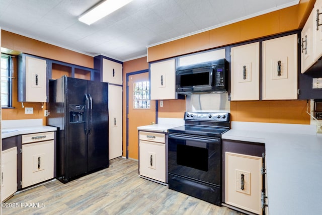 208 W Church St, Opelousas, LA 70570 - kitchen featuring black appliances, crown molding, light countertops, light wood-style flooring, and white cabinetry