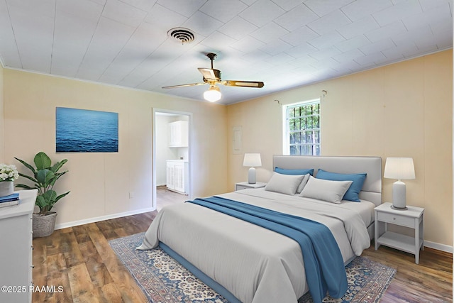208 W Church St, Opelousas, LA 70570 - bedroom with wood finished floors, ceiling fan, and ensuite bath