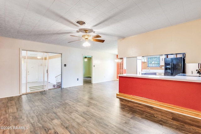 208 W Church St, Opelousas, LA 70570 - unfurnished living room featuring wood finished floors and a ceiling fan
