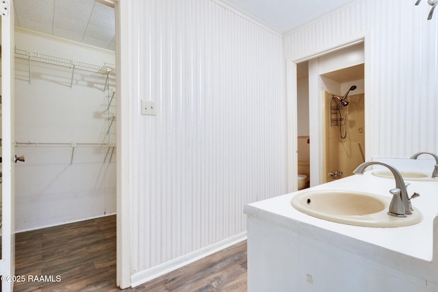 208 W Church St, Opelousas, LA 70570 - bathroom with ornamental molding, wood finished floors, vanity, and a walk in closet
