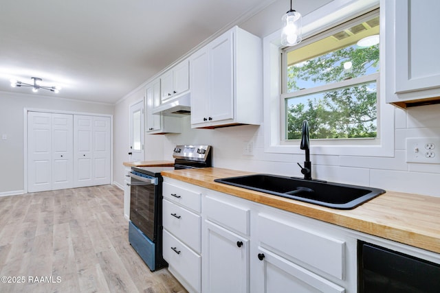 126 Lindsey Cir, Carencro, LA 70520 - kitchen with stainless steel range with electric stovetop, under cabinet range hood, tasteful backsplash, butcher block counters, and white cabinetry