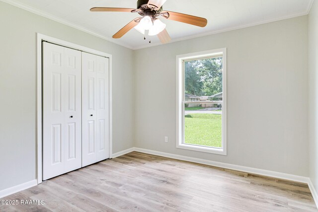 126 Lindsey Cir, Carencro, LA 70520 - unfurnished bedroom with ornamental molding, light wood-style floors, a closet, and a ceiling fan
