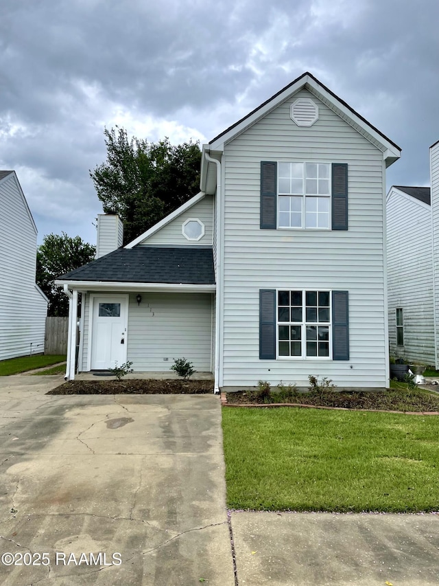 113 Earline Dr, Lafayette, LA 70506 - traditional-style house with a front lawn, a chimney, and roof with shingles