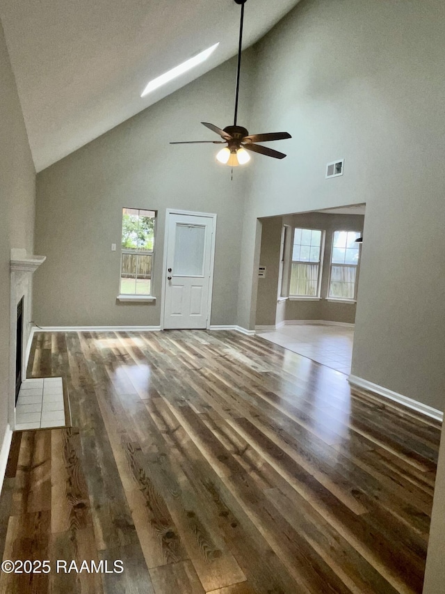 113 Earline Dr, Lafayette, LA 70506 - unfurnished living room with high vaulted ceiling, a ceiling fan, healthy amount of natural light, and wood finished floors