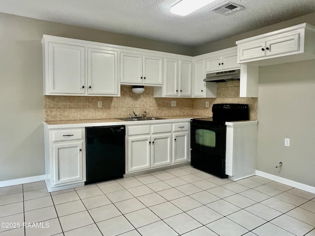 113 Earline Dr, Lafayette, LA 70506 - kitchen featuring black appliances, under cabinet range hood, a textured ceiling, tasteful backsplash, and white cabinets