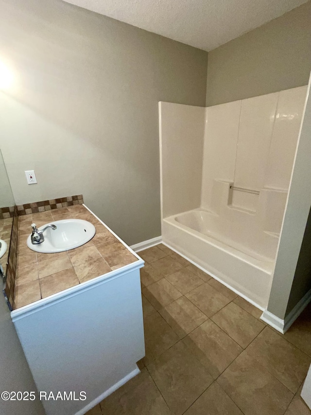 113 Earline Dr, Lafayette, LA 70506 - bathroom with vanity, bathtub / shower combination, tile patterned flooring, and a textured ceiling