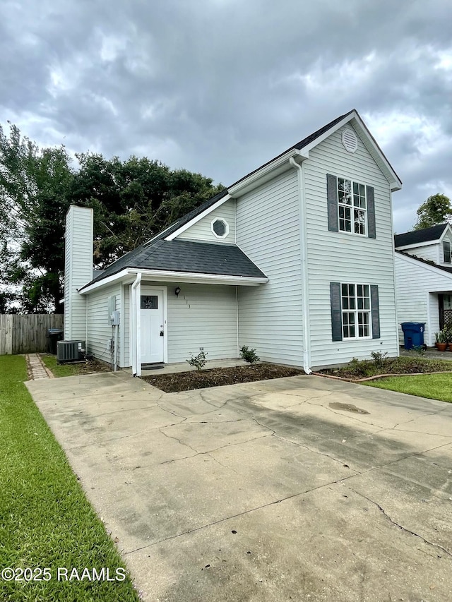113 Earline Dr, Lafayette, LA 70506 - view of side of property with a chimney, a shingled roof, and concrete driveway