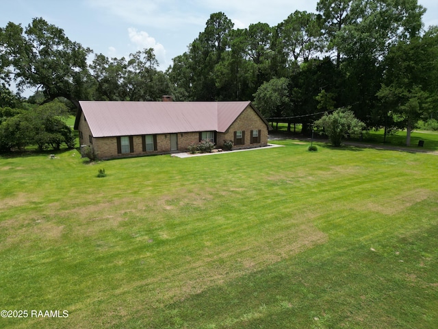 6516 Daspit Rd, New Iberia, LA 70563 - view of front of home featuring a front yard, a metal roof, and a chimney