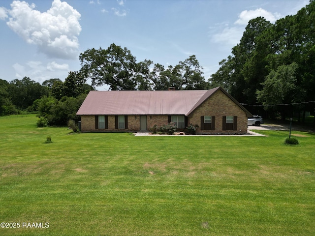 6516 Daspit Rd, New Iberia, LA 70563 - view of front of home with a front lawn, brick siding, and a metal roof