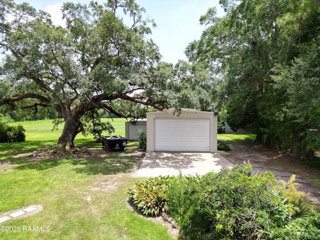 6516 Daspit Rd, New Iberia, LA 70563 - view of grassy yard with an outbuilding, a detached garage, and driveway