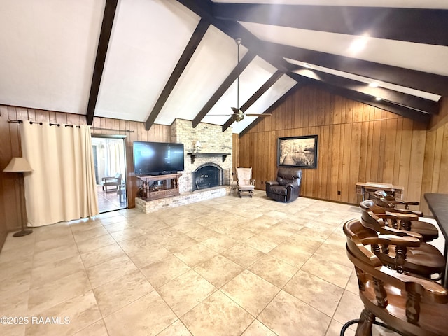 6516 Daspit Rd, New Iberia, LA 70563 - tiled living area with wood walls, a ceiling fan, and a fireplace