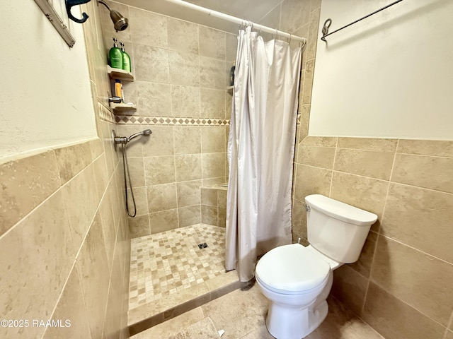 6516 Daspit Rd, New Iberia, LA 70563 - bathroom featuring a tile shower, tile walls, and a wainscoted wall