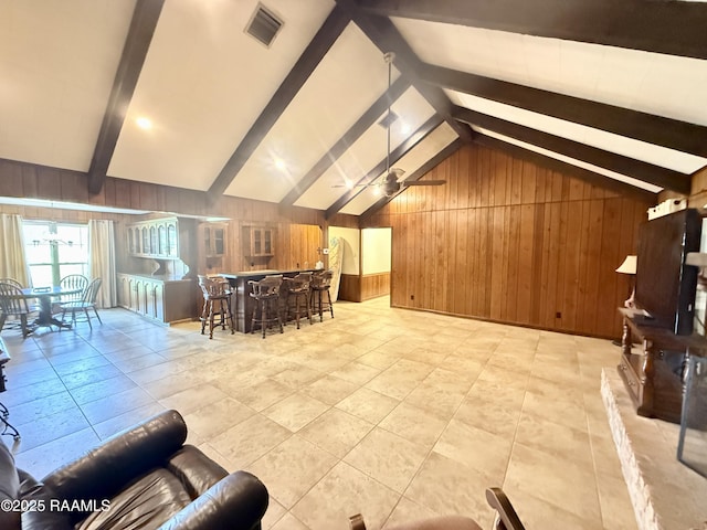 6516 Daspit Rd, New Iberia, LA 70563 - living area featuring wooden walls, a ceiling fan, and bar