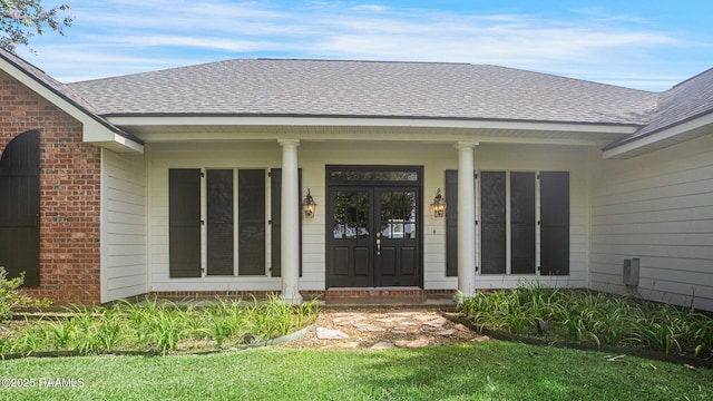 810 Fenetre Rd, Scott, LA 70583 - property entrance featuring roof with shingles, brick siding, and a porch
