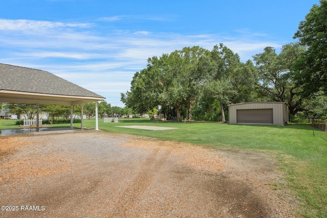 810 Fenetre Rd, Scott, LA 70583 - view of green lawn featuring a detached garage and an outbuilding