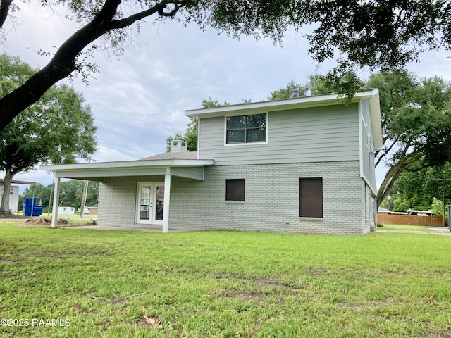 311 Fernway Ln, Duson, LA 70529 - rear view of property featuring brick siding and a lawn