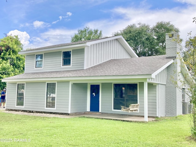 311 Fernway Ln, Duson, LA 70529 - view of front of house with roof with shingles, a front yard, a chimney, and a porch