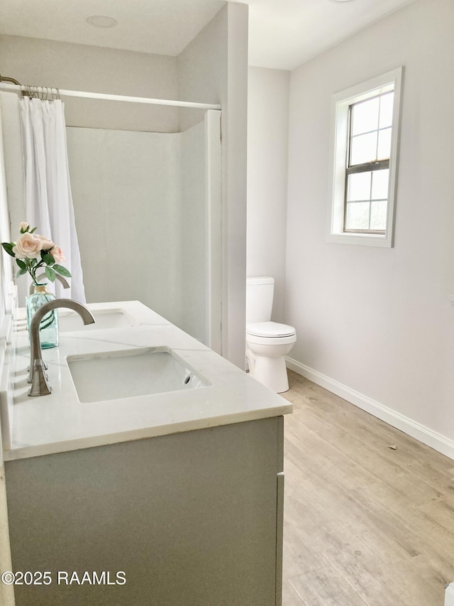 311 Fernway Ln, Duson, LA 70529 - bathroom featuring double vanity, a shower with curtain, and wood finished floors