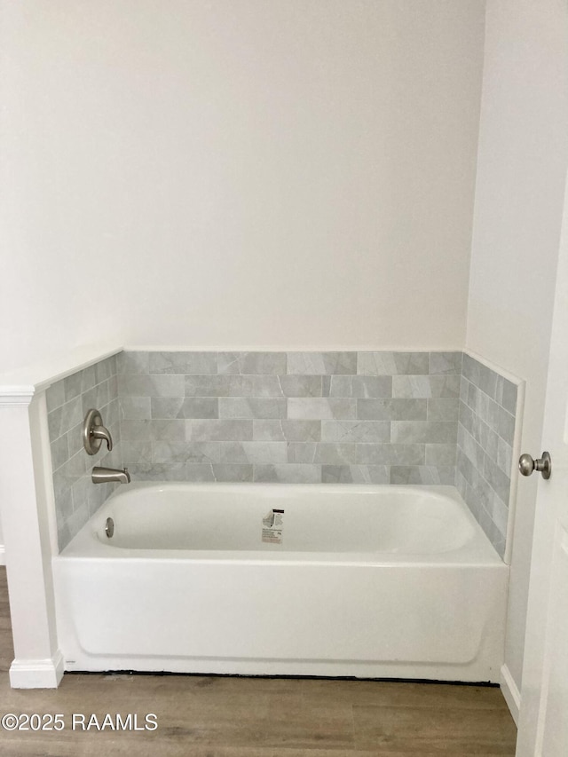311 Fernway Ln, Duson, LA 70529 - bathroom featuring a garden tub and wood finished floors