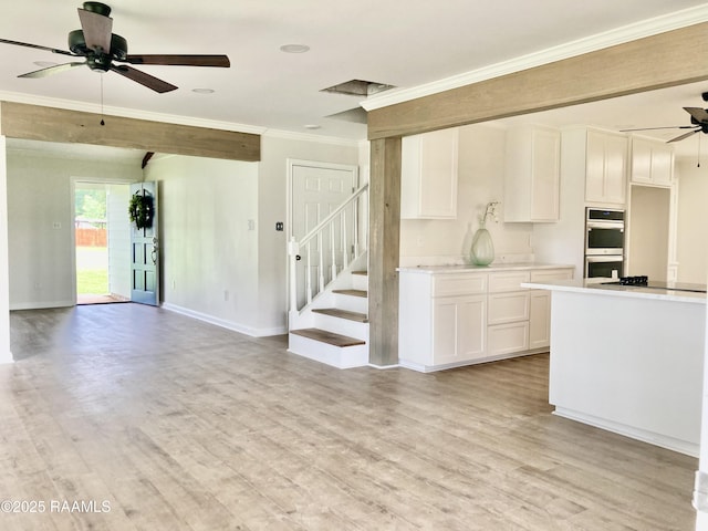 311 Fernway Ln, Duson, LA 70529 - unfurnished living room with ceiling fan, ornamental molding, light wood-type flooring, and stairway