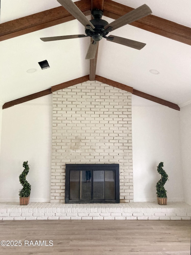 311 Fernway Ln, Duson, LA 70529 - detailed view of beam ceiling, a fireplace, ceiling fan, and wood finished floors