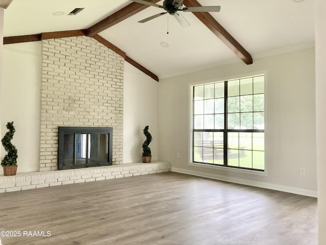 311 Fernway Ln, Duson, LA 70529 - unfurnished living room featuring a ceiling fan, wood finished floors, and a brick fireplace