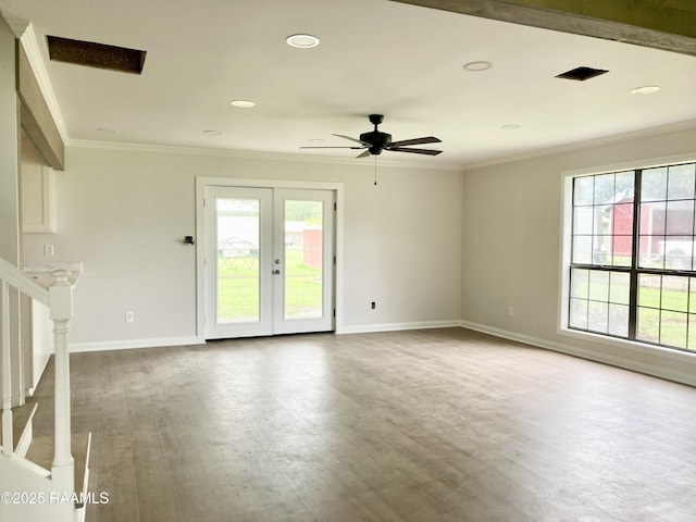 311 Fernway Ln, Duson, LA 70529 - spare room with plenty of natural light, wood finished floors, ceiling fan, ornamental molding, and stairway