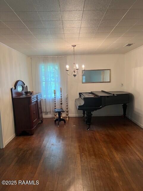 526 E Main St, New Iberia, LA 70560 - dining room featuring dark wood-style floors and a chandelier