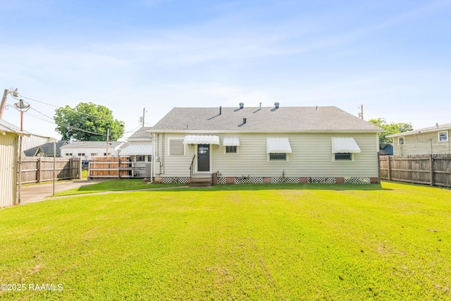 124 Taylor St, New Iberia, LA 70560 - back of property featuring entry steps, a fenced backyard, and a shingled roof