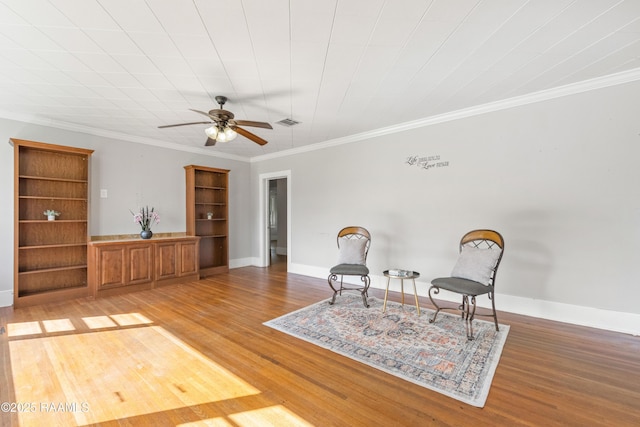 124 Taylor St, New Iberia, LA 70560 - living area with light wood-type flooring, ceiling fan, and ornamental molding