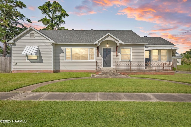 124 Taylor St, New Iberia, LA 70560 - view of front of property with roof with shingles and a front lawn