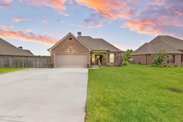 1181 Grand Loop, Breaux Bridge, LA 70517 - view of front of property featuring brick siding, driveway, an attached garage, and a chimney