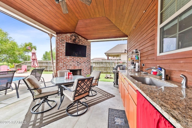 1181 Grand Loop, Breaux Bridge, LA 70517 - view of patio with an outdoor brick fireplace, area for grilling, ceiling fan, and outdoor dining space