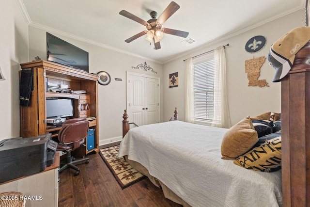 1181 Grand Loop, Breaux Bridge, LA 70517 - bedroom with dark wood-type flooring, ornamental molding, a desk, a ceiling fan, and a closet