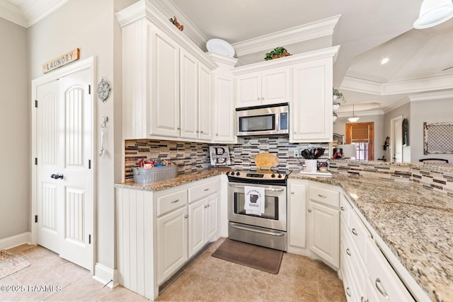 1181 Grand Loop, Breaux Bridge, LA 70517 - kitchen featuring appliances with stainless steel finishes, backsplash, crown molding, white cabinets, and light tile patterned flooring