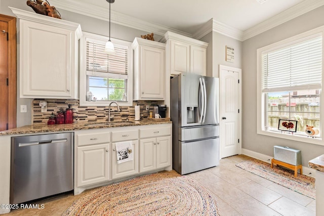 1181 Grand Loop, Breaux Bridge, LA 70517 - kitchen with stainless steel appliances, backsplash, stone countertops, white cabinets, and ornamental molding