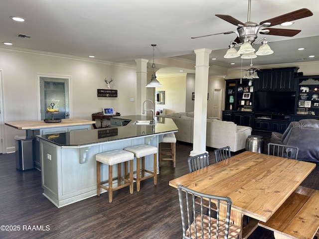 7421 W Congress St, Duson, LA 70529 - dining room featuring ceiling fan, crown molding, dark wood finished floors, ornate columns, and recessed lighting