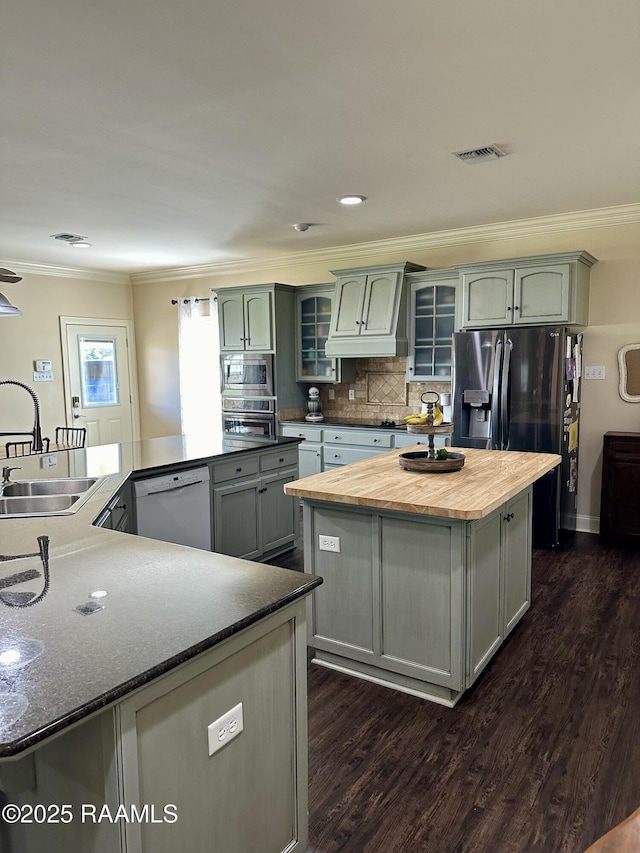 7421 W Congress St, Duson, LA 70529 - kitchen featuring a spacious island, appliances with stainless steel finishes, ornamental molding, dark wood-style floors, and wood counters
