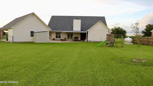 7421 W Congress St, Duson, LA 70529 - back of property with a playground, a patio, a fenced backyard, french doors, and roof with shingles