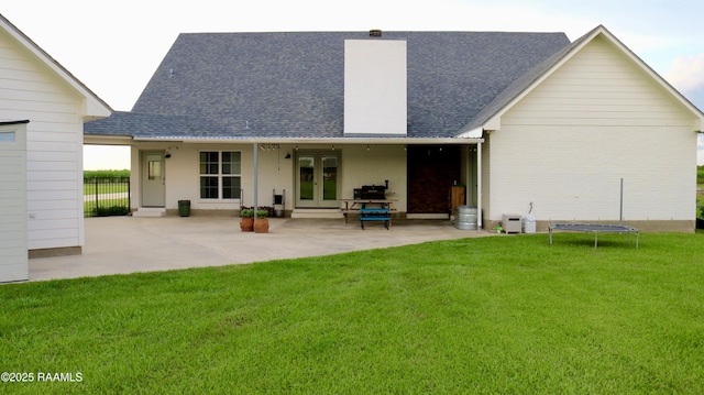 7421 W Congress St, Duson, LA 70529 - back of property with a trampoline, a patio, and roof with shingles