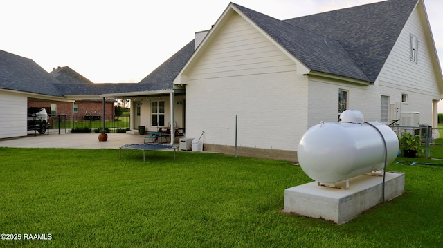 7421 W Congress St, Duson, LA 70529 - back of property with a shingled roof, a patio, and brick siding