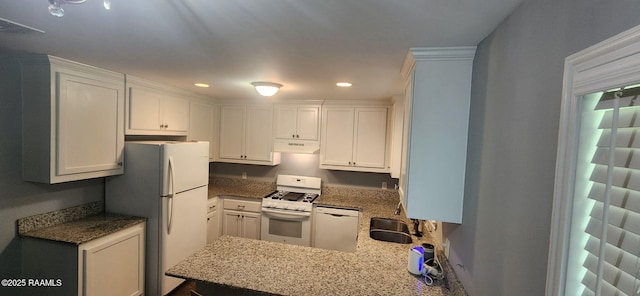 217 Marie St, Scott, LA 70583 - kitchen with white appliances, under cabinet range hood, white cabinets, recessed lighting, and light stone counters