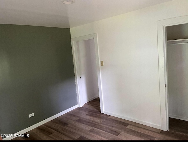 1136 Tupelo St, New Iberia, LA 70560 - unfurnished bedroom with dark wood finished floors and a closet